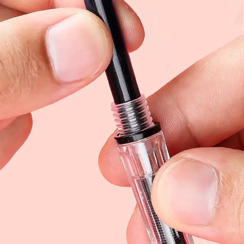 Fountain pen ink cartridge being inserted into a black pen; universal large-capacity ink