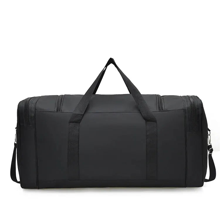 Oversized black handbag with dual top handles and removable shoulder strap for travel, gym, or outdoor use
