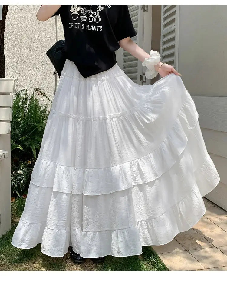 White tiered ruffle-hem maxi skirt with high waist and flowing A-line layers
