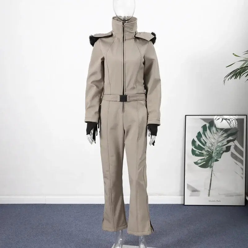 Beige one-piece ski suit with high-waist belt, high collar, faux-fur shoulder accents