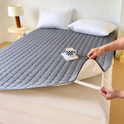 Waterproof quilted mattress protector topper in grey; thickened, breathable, fits single or double bed.