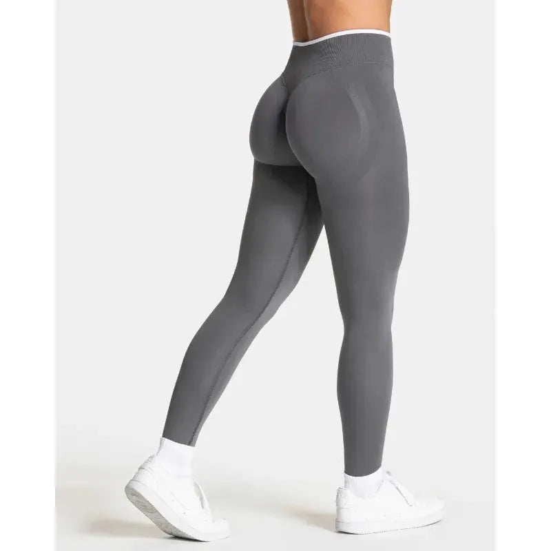 Women's grey seamless yoga leggings with high waist and white-edged waistband for gym workouts