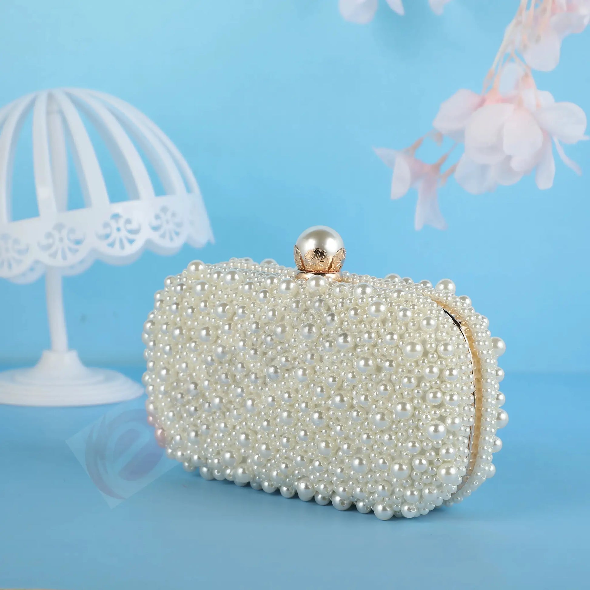 Handcrafted pearl evening bag by Simples Market, white beaded clutch with gold-tone clasp.
