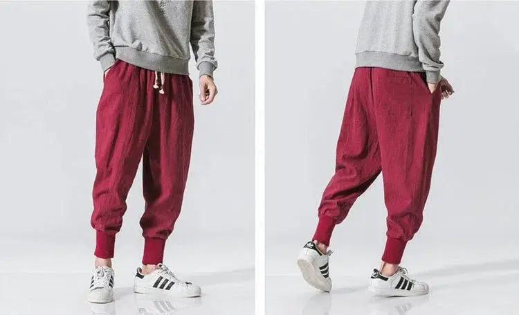 Cotton linen harem pants for men in burgundy, drop-crotch streetwear joggers with cuffed ankles.