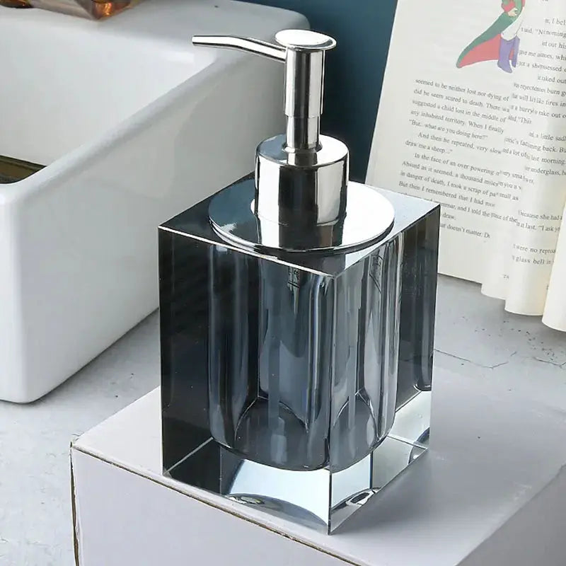 Glass lotion dispenser with chrome pump; clear faceted crystal bottle for bathroom use
