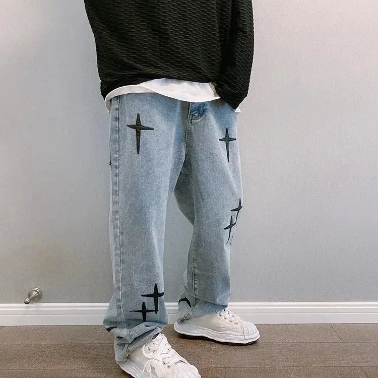 Men's light-wash denim cargo pants with black star patches, loose wide-leg fit