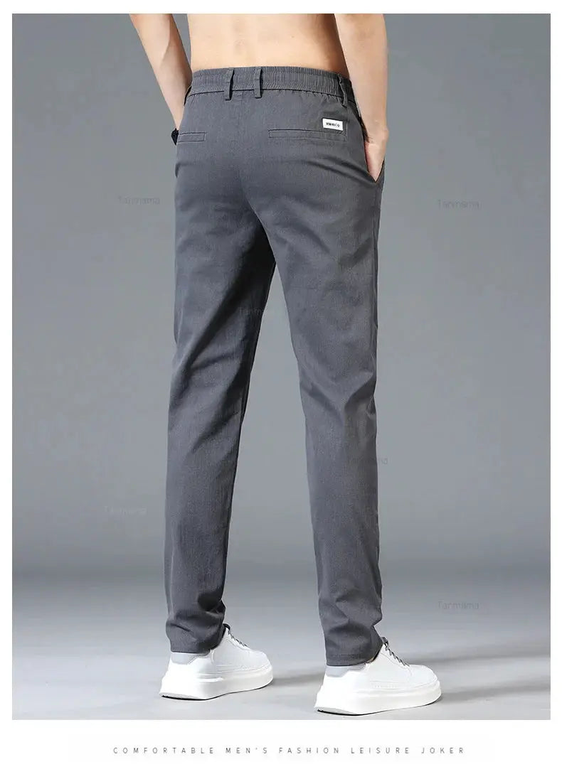 Simples Market men's casual pants in blue-gray, elastic waist, slim straight fit with back pockets and small brand tag.
