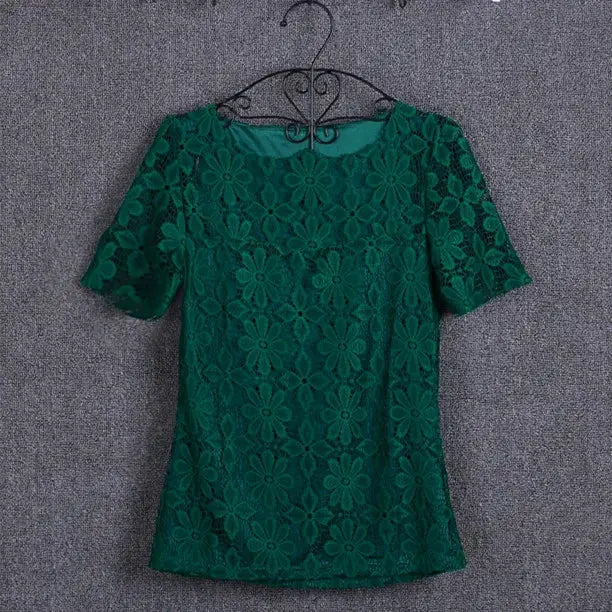 Summer lace blouse top in green with floral pattern and short sleeves on a hanger