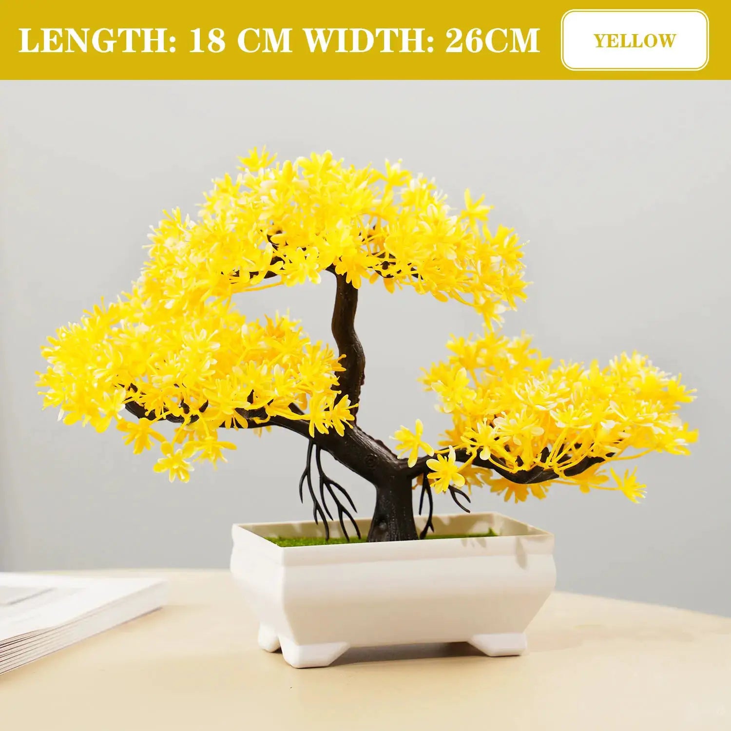 Artificial bonsai tree with bright yellow blossoms in a white ceramic pot for tabletop decor