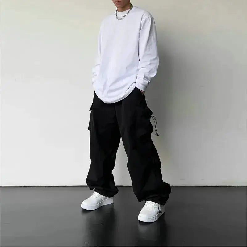 Men's cargo pants, black loose-fit wide-leg with drawstrings and cargo pockets.