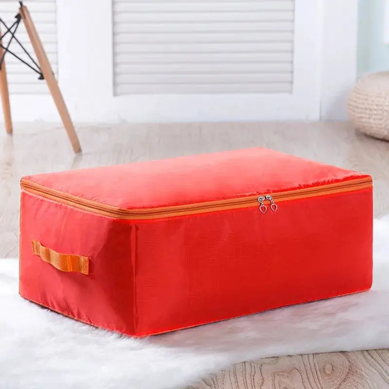 Clothes organizer bag by Simples Market, large red fabric with orange zipper for bedding storage