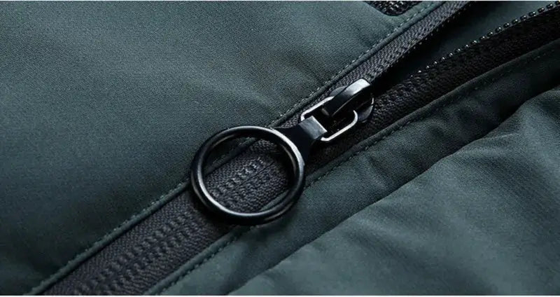 Men's hooded down jacket zipper pull close-up in dark green