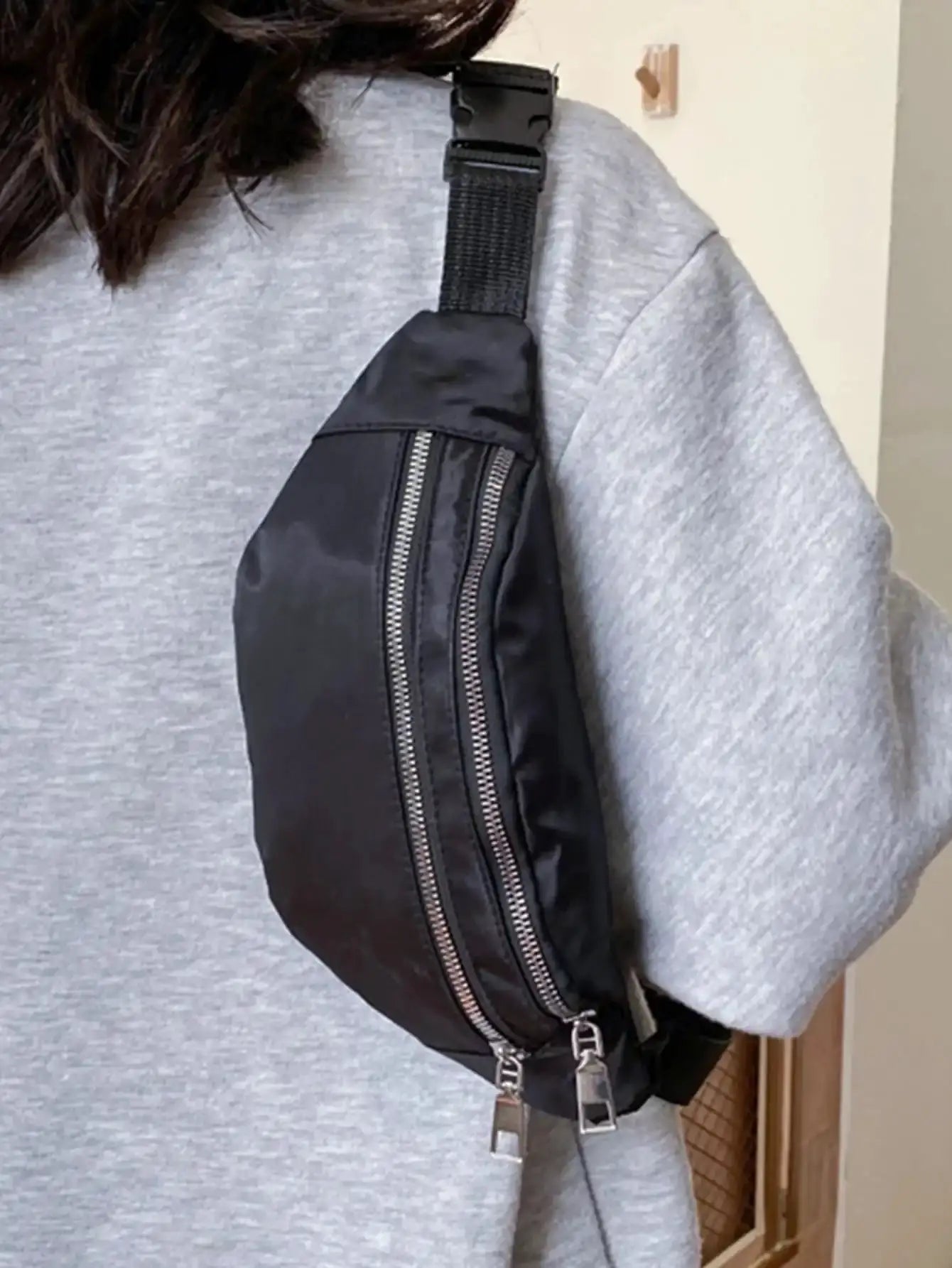 Simples Market fanny pack waist bag worn crossbody on gray sweatshirt; black nylon with double-zip pockets