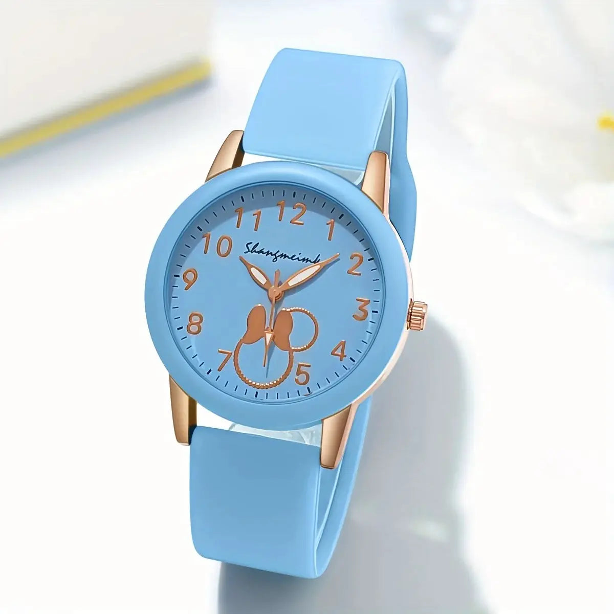 Casual round women's quartz watch with light blue silicone band and rose-gold case, orange numerals.