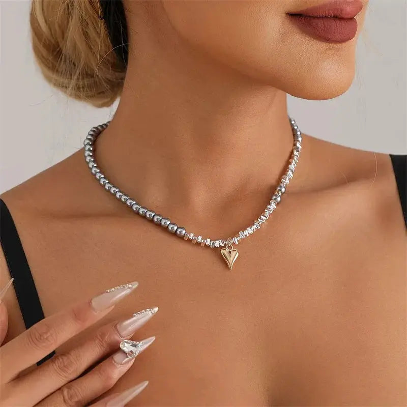 Y2K heart beaded crystal choker necklace by Simples Market in silver-gray beads with gold heart pendant.