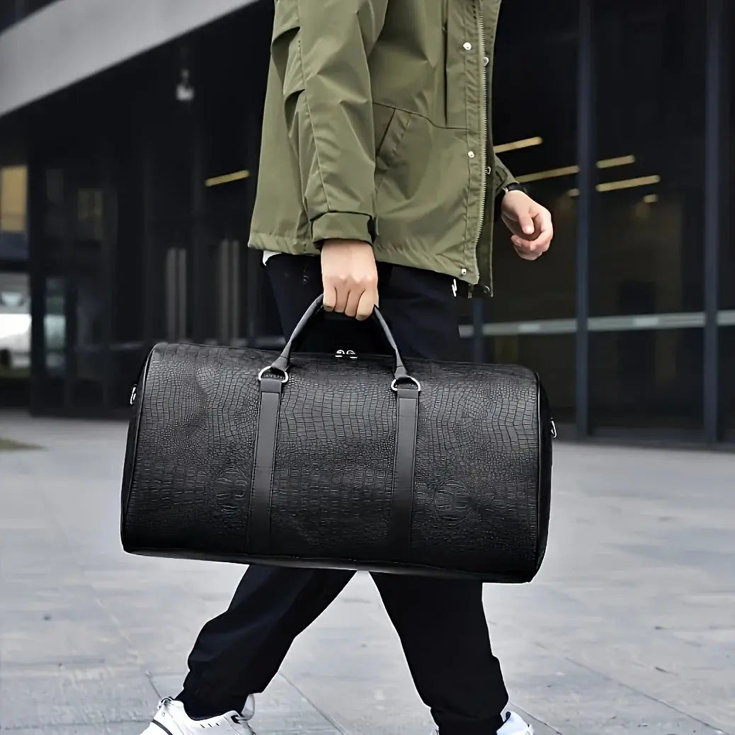 Large black crocodile-textured travel duffel bag with dual top handles