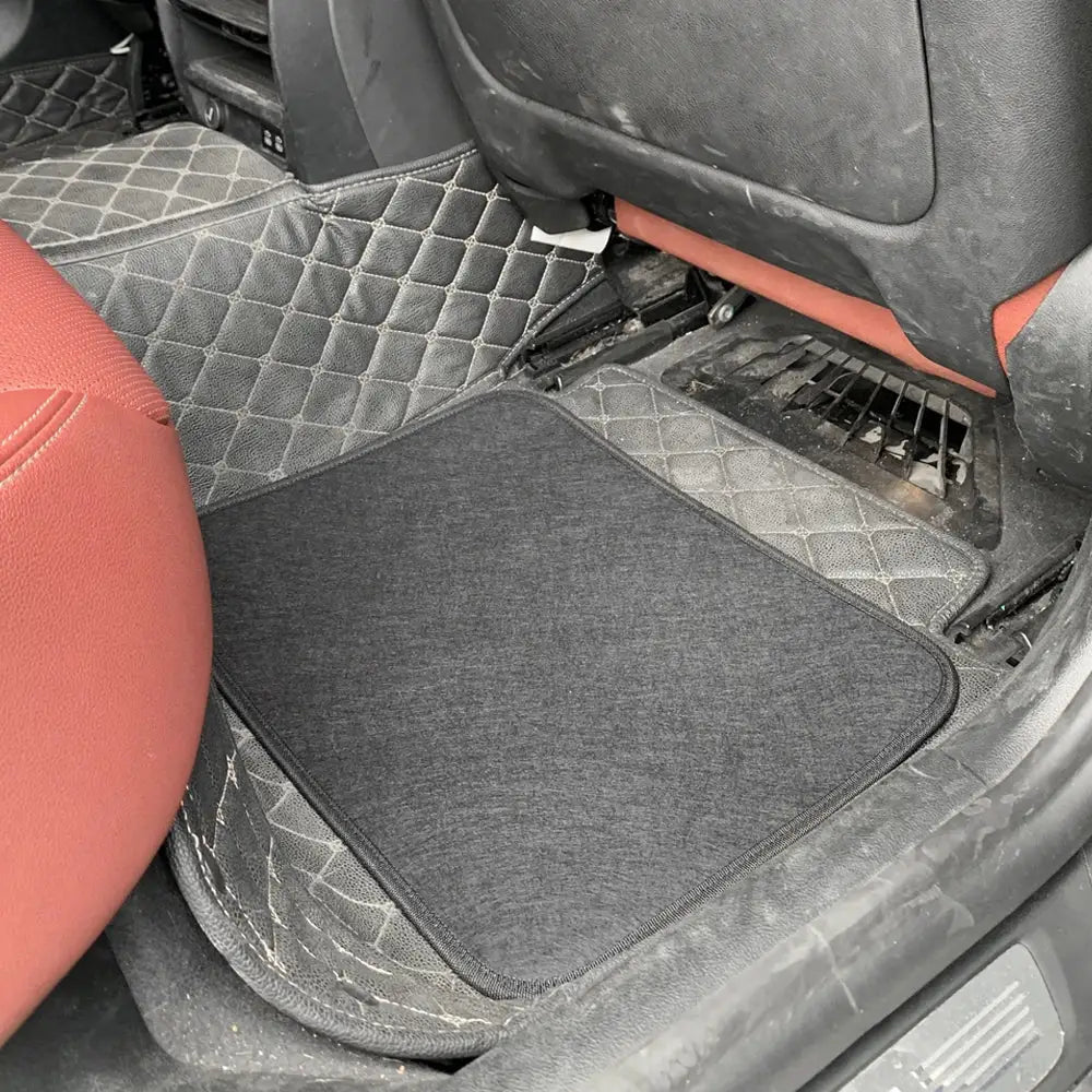 Car floor mats set for front and rear seats, universal fit; black top mat over diamond-quilted base.