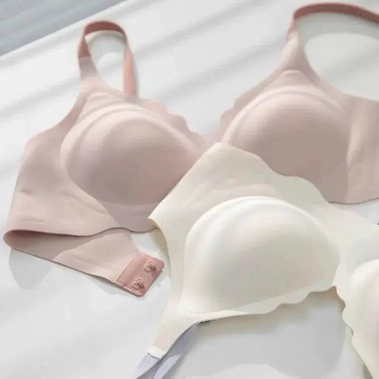 No Trace Top bra set; two pale pink and white bras with adjustable straps.