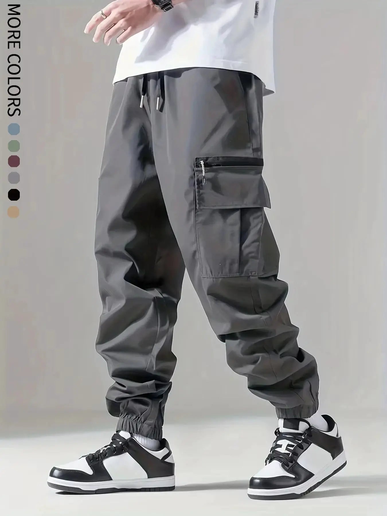 Men's cargo pants by Simples Market in gray with drawstring waist and zip thigh pocket.