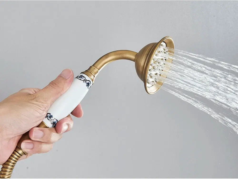 Antique brass handheld shower head with ceramic white handle and 150cm hose by Simples Market