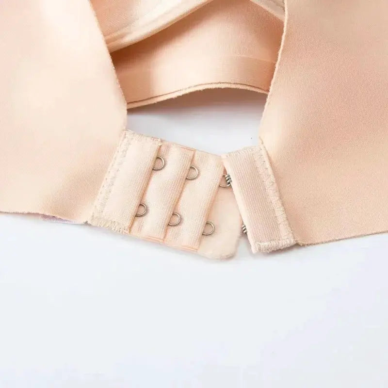 Women's peach seamless bra with back hook closures and smooth fabric