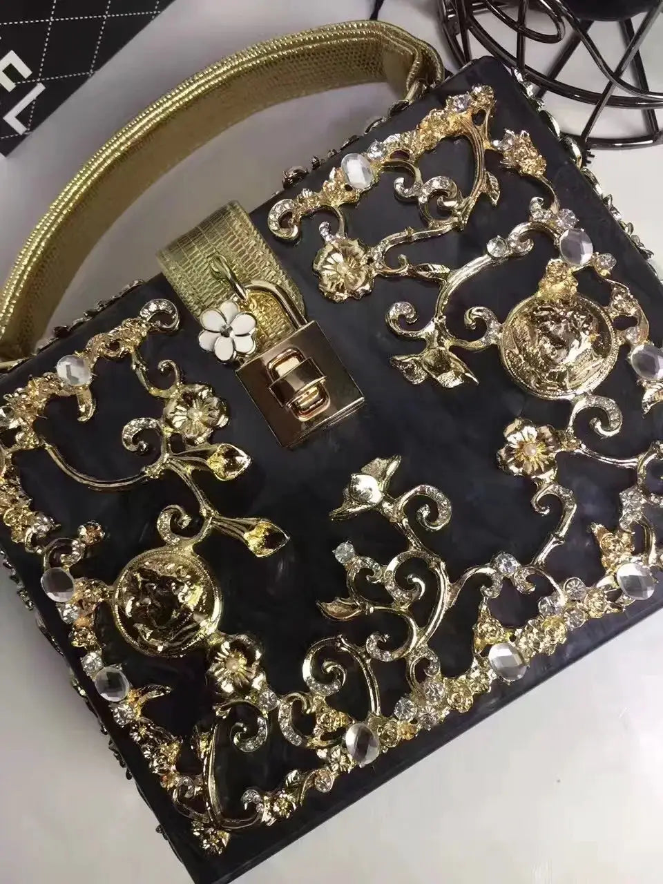 Box clutch evening bag with gold filigree lattice and crystal floral accents on black fabric Simples Market