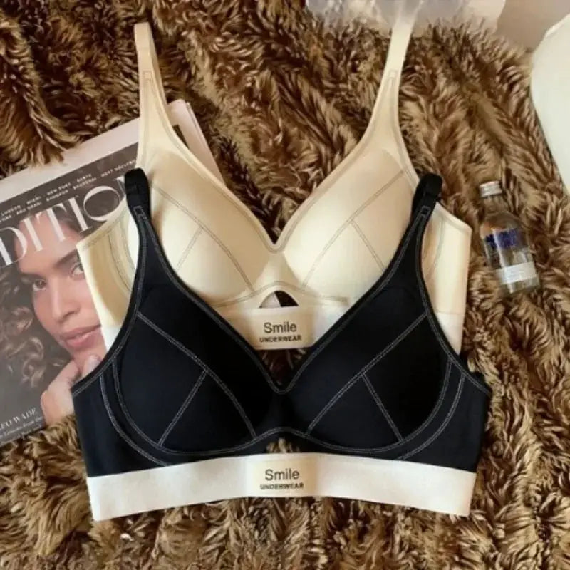 Two-tone women's bras set in black and beige with Smile Underwear branding
