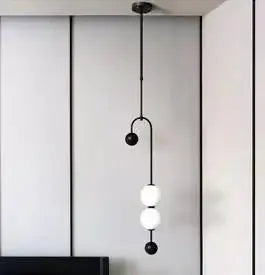 Nordic minimalist chandelier pendant light with black cord and three white globe pendants.