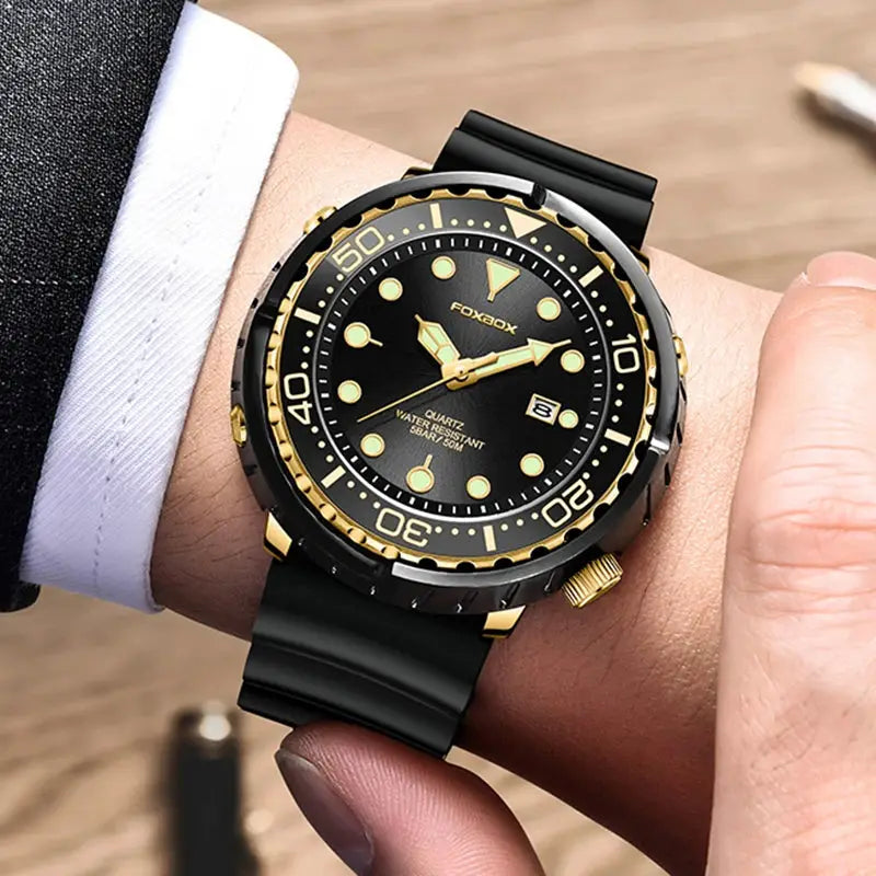 Foxbox diver watch for men with black dial, gold-tone bezel, date window, and black rubber strap