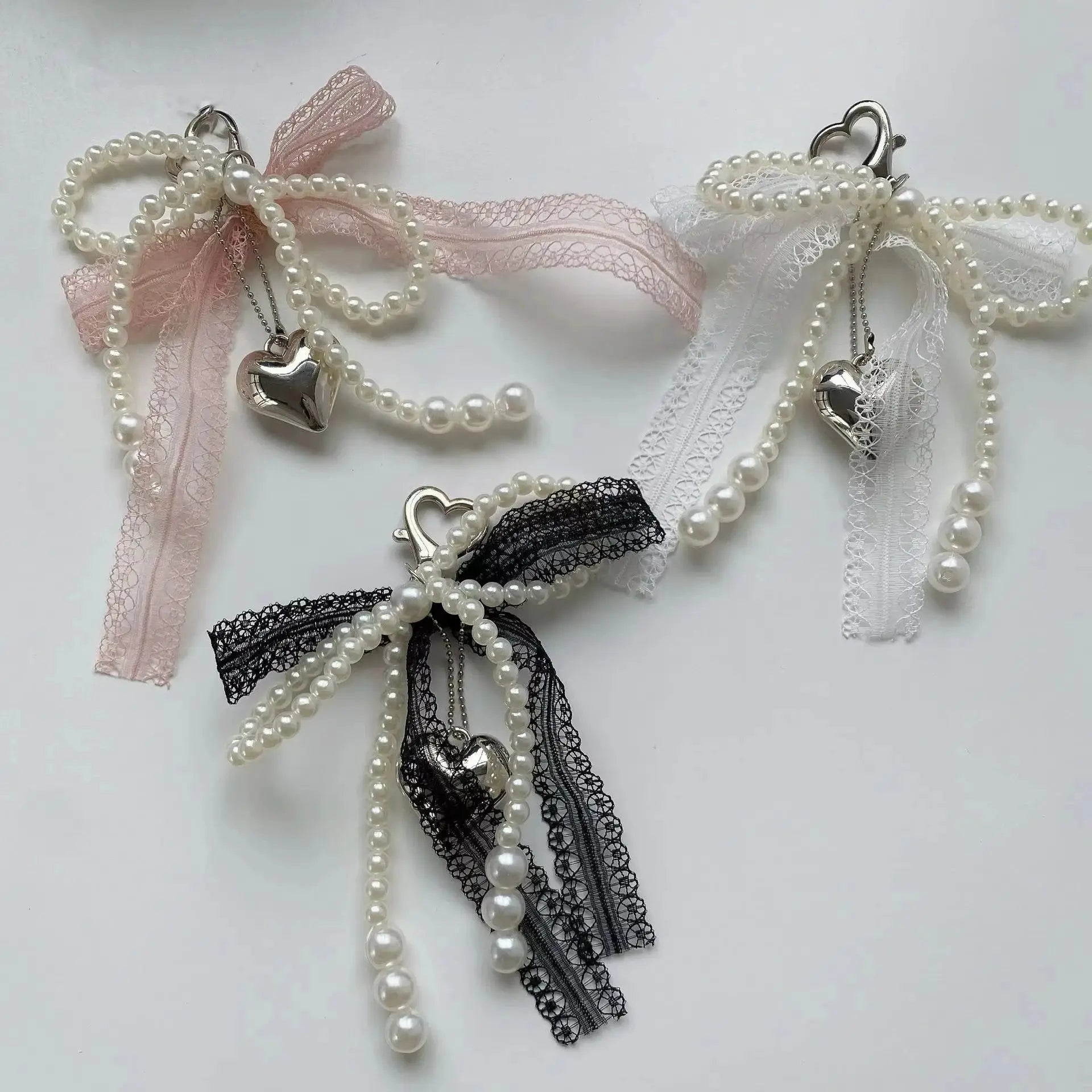 Pearl bead keychain with heart charm and lace bowknot ribbons in pink, white and black