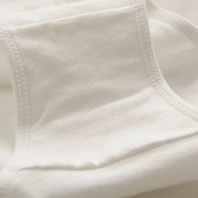 Women's briefs by Simples Market; white fabric close-up showing soft material and neat stitching