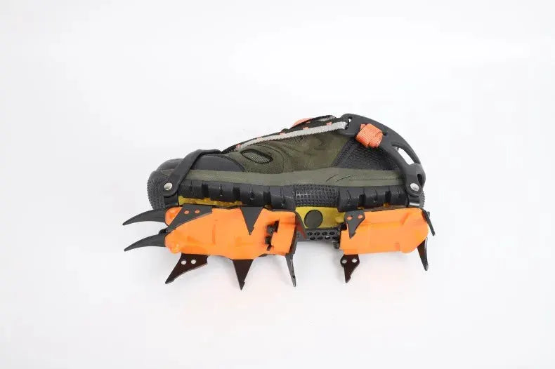 Simples Market 12-tooth ice crampons for sport shoes; orange spike plates under a dark green hiking shoe