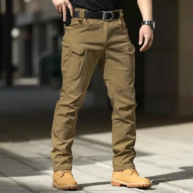 Mens waterproof cargo pants by Simples Market, khaki with multiple pockets and tactical design.