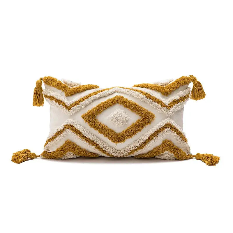 Rectangular decorative pillow cover; white base with mustard gold tufted diamond pattern and tassel trim.