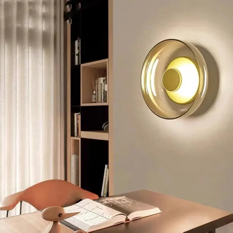 Nordic LED glass wall sconce with concentric rings and warm glow in a study room.