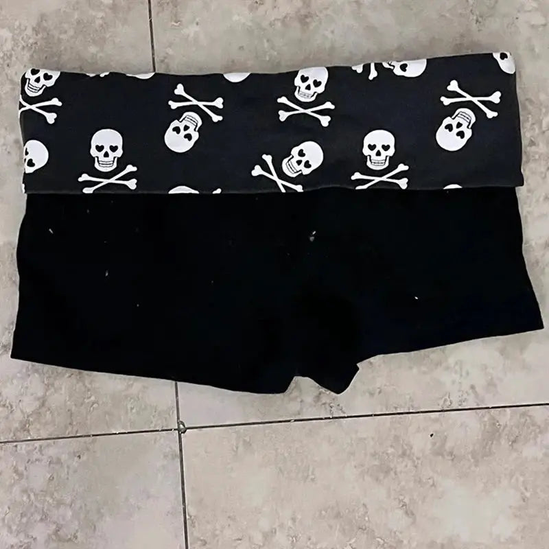 Skull-print color-block shorts for women; black solid lower panel with rolled waistband, casual streetwear