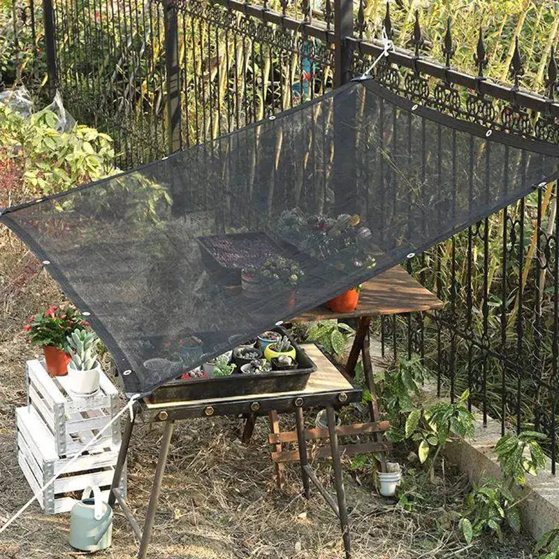 Shade net black HDPE garden sun shade over a table with potted plants