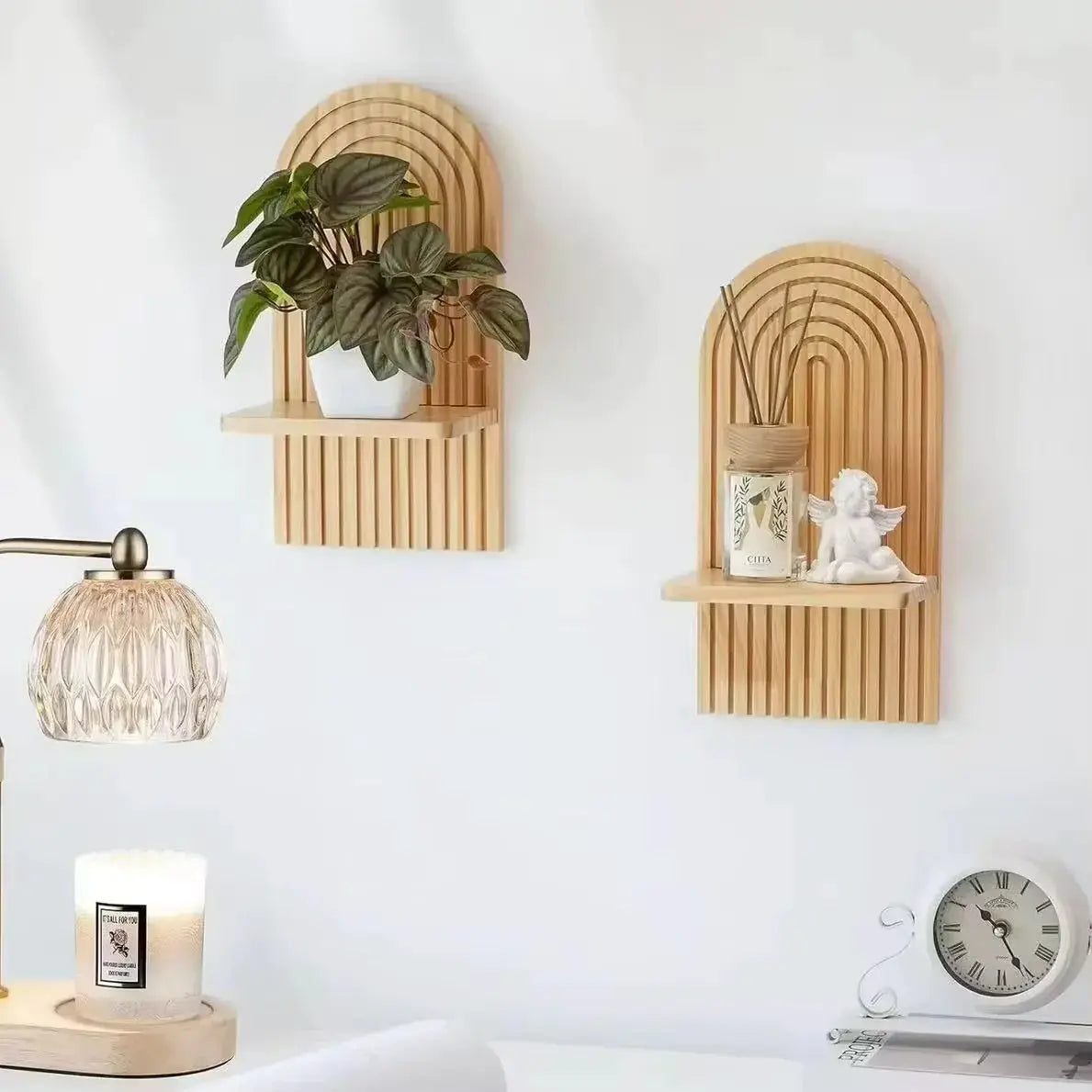 Two boho-style wooden wall shelves with arched geometric back panels in natural wood finish