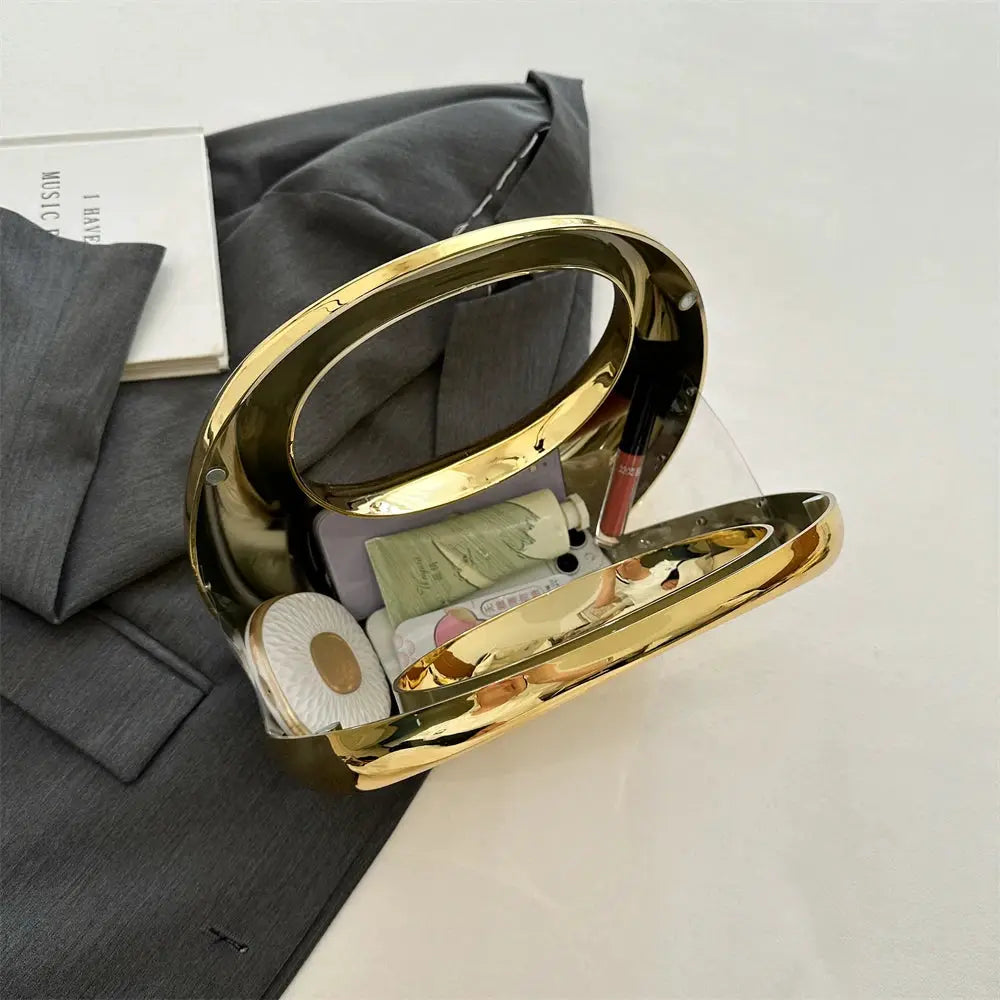 MOODS golden evening handbag with round gold-tone handle, PVC wrist clutch