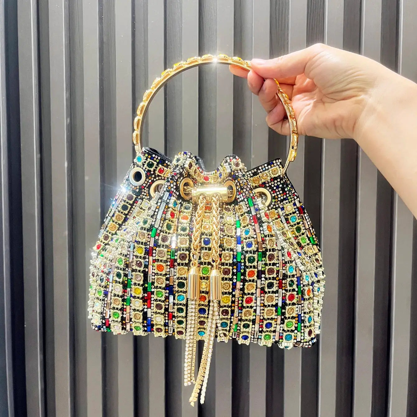Crystal rhinestone bucket clutch handbag with multicolor stones and a gold ring handle