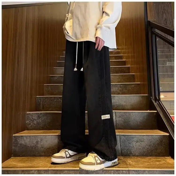 Men's black denim jeans with elastic drawstring waist and loose straight-leg, long length