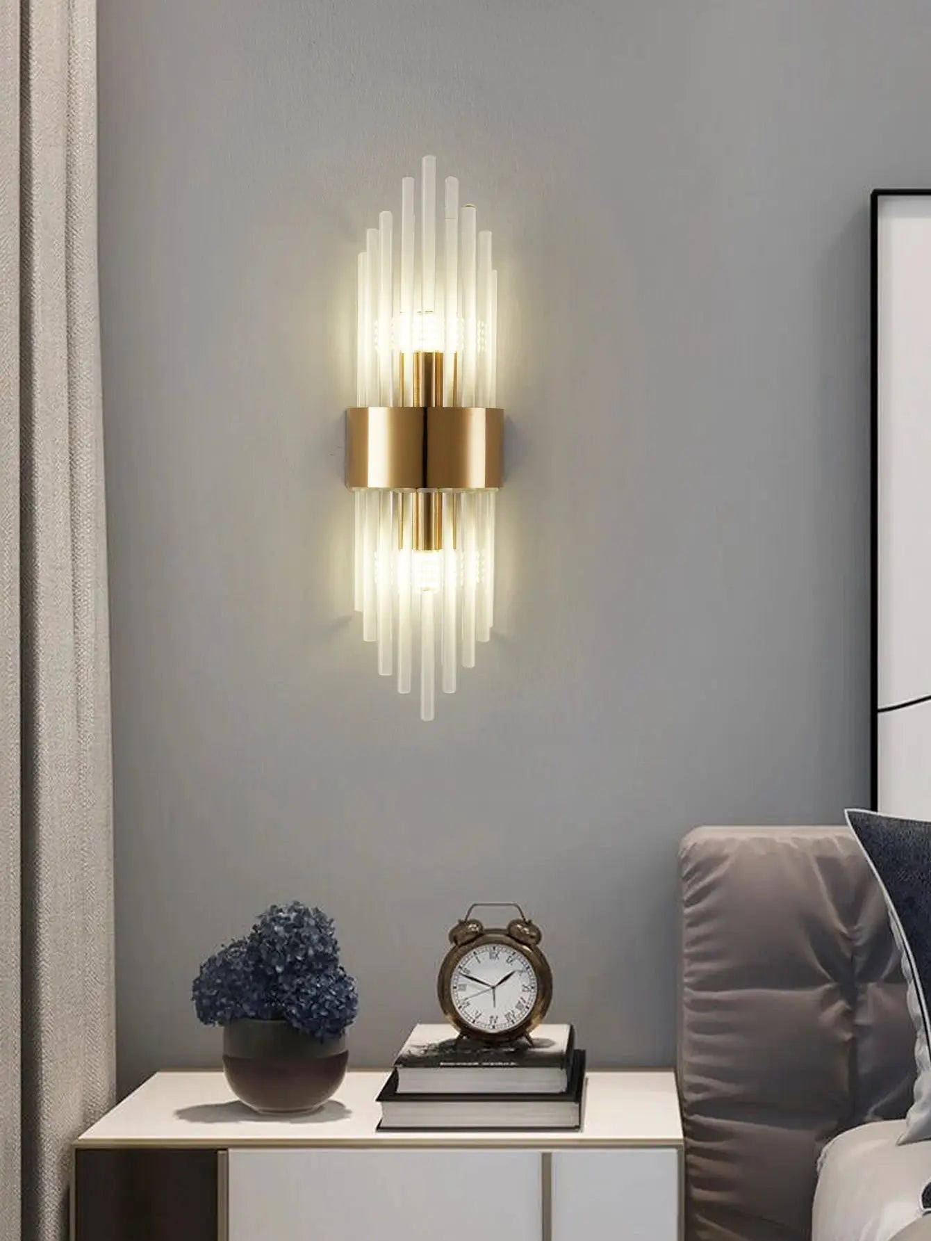 Crystal wall sconce by Simples Market, gold stainless steel with vertical glass rods and a G9 light source.
