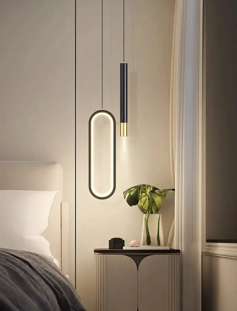 Nordic LED pendant lights pair; glowing rounded-rectangle pendant and black cylindrical pendant with gold tip.