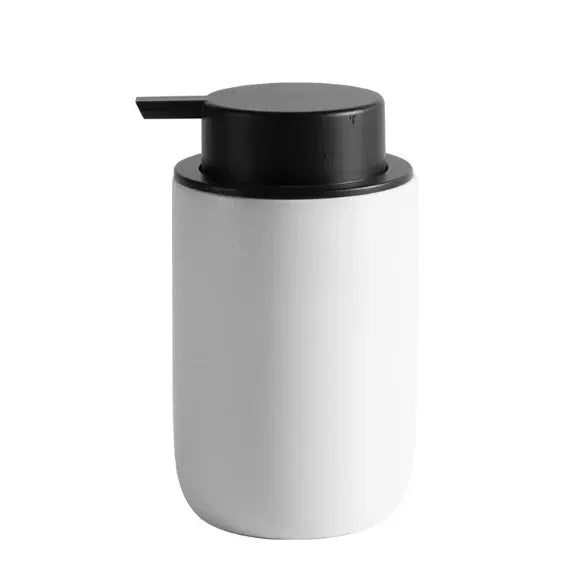 Ceramic bathroom soap dispenser with black pump on a white cylindrical bottle
