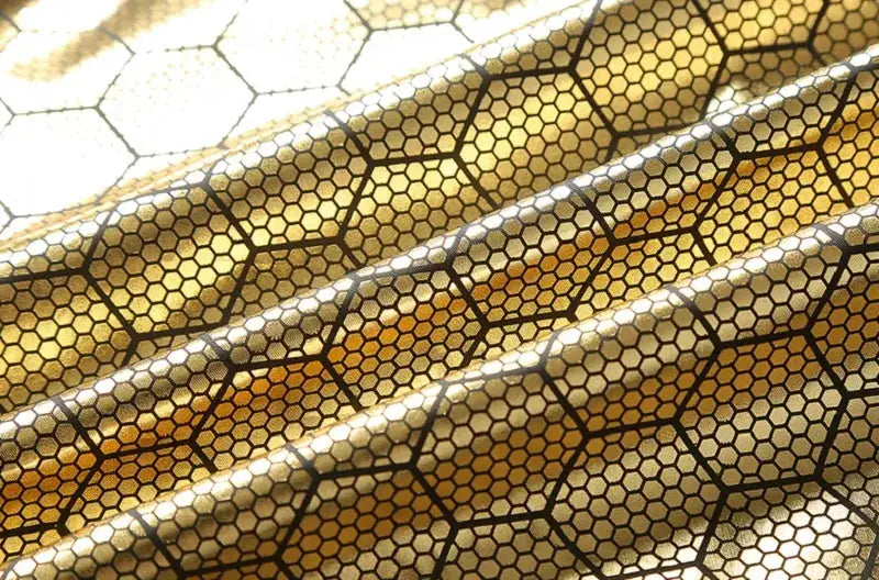 Gold honeycomb-patterned puffer jacket fabric by Simples Market