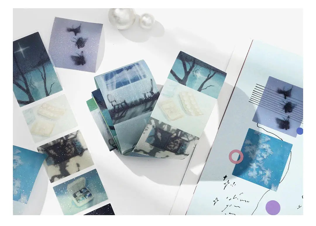 Decorative PET tape roll set by Simples Market with blue-green landscape designs for journaling.