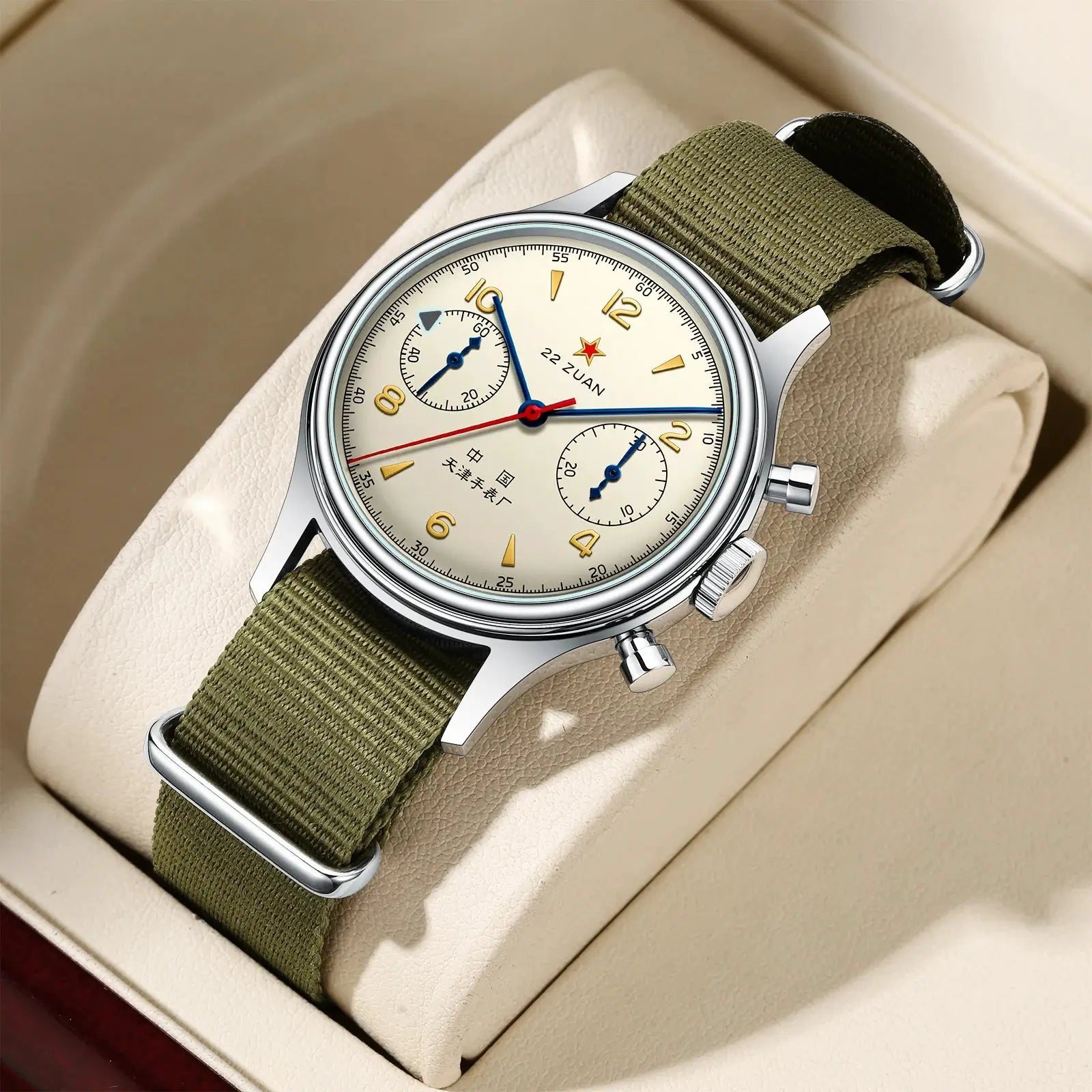 Seagull 1963 International Edition chronograph watch with cream dial, gold numerals, blue hands, olive strap.