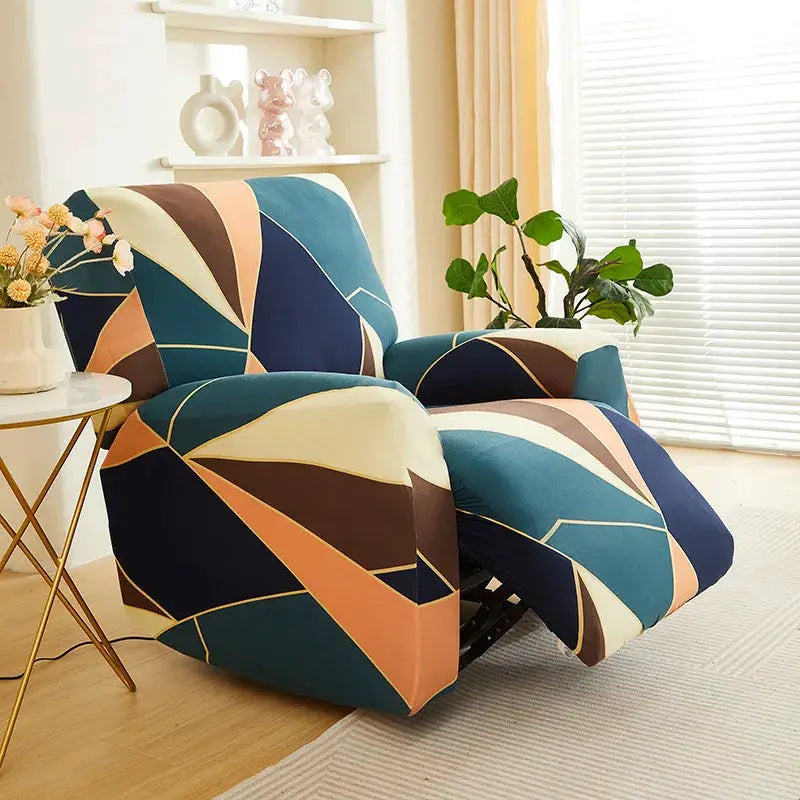 Elastic recliner sofa cover by Simples Market with a geometric print in teal, navy, peach and brown on an armchair.