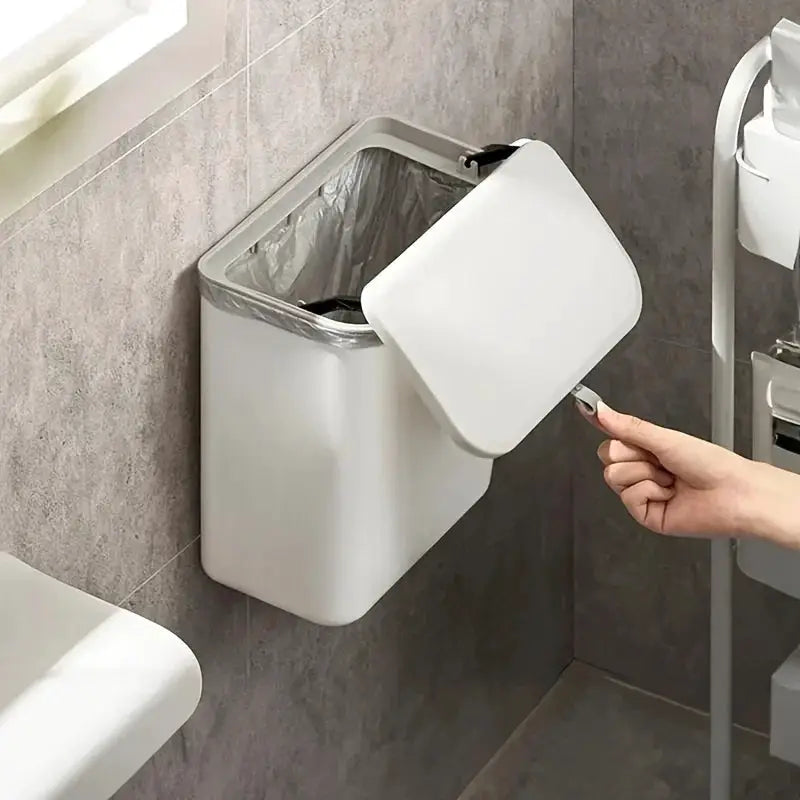 White wall-mounted trash bin with open lid; durable plastic for kitchen or bathroom