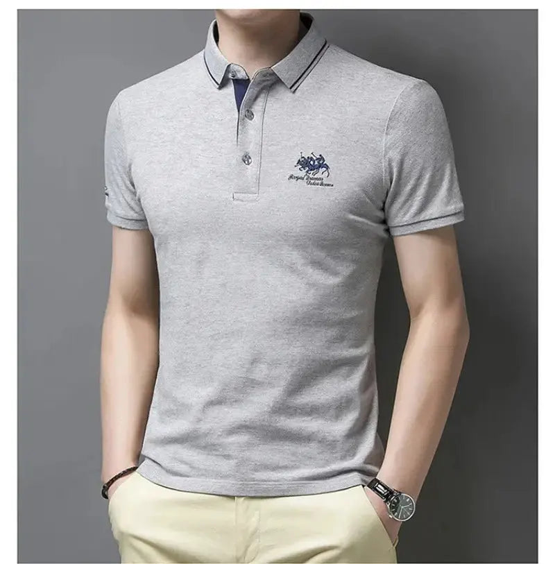 Men's light gray polo shirt from Simples Market with navy embroidered crest, short sleeves.